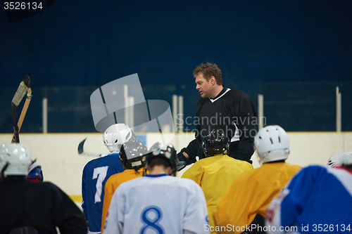 Image of ice hockey players team meeting with trainer