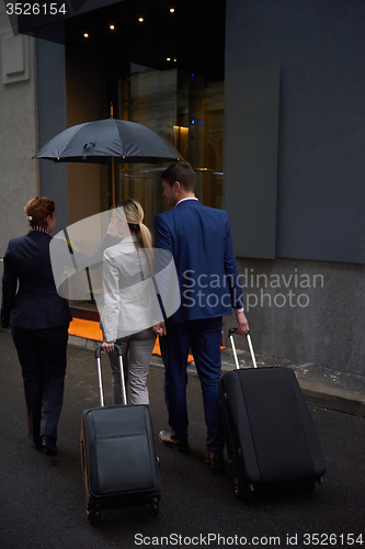 Image of business people couple entering  hotel