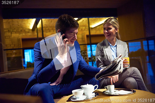 Image of business couple take drink after work