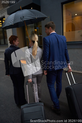 Image of business people couple entering  hotel