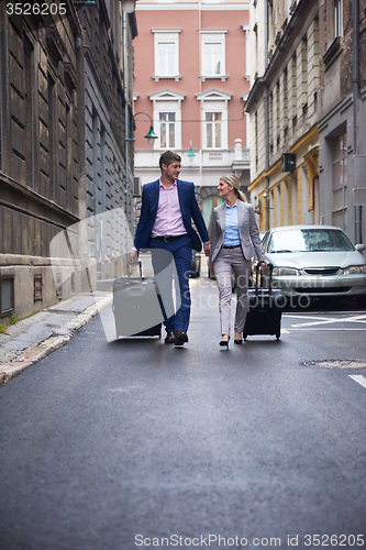 Image of business people couple entering  hotel