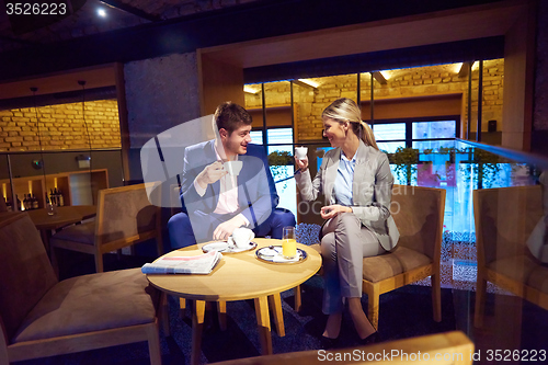 Image of business couple take drink after work