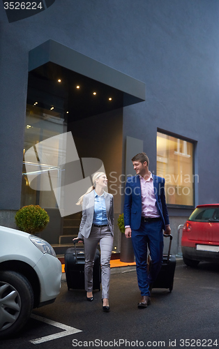 Image of business people couple entering  hotel