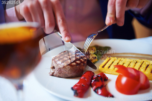 Image of business man eating tasty beef stak