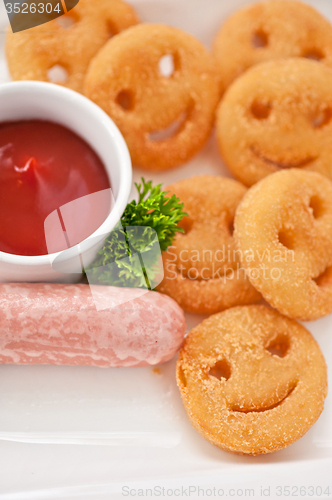 Image of sausages with smiling potatoes