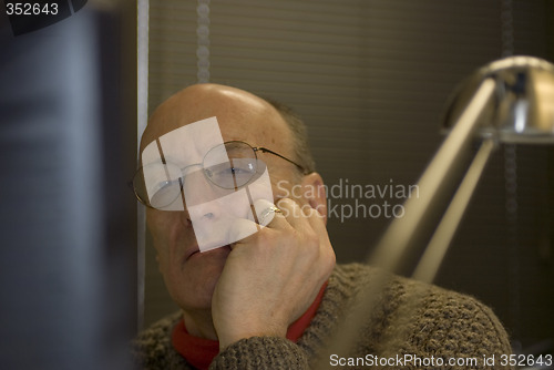 Image of man looking at computer screen in office