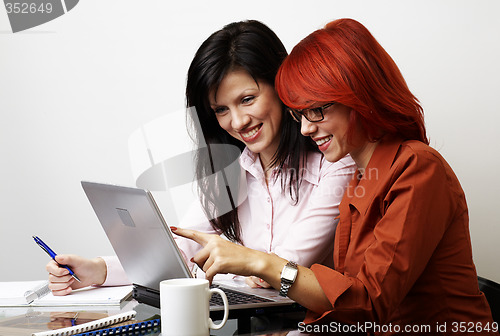 Image of two beautiful women are working
