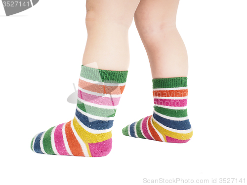 Image of Toddler standing in striped socks and bare legs isolated on whit