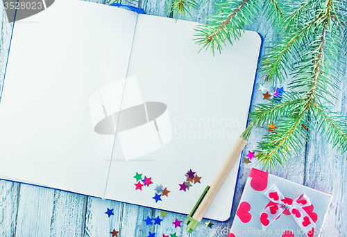 Image of notebook and christmas decoration