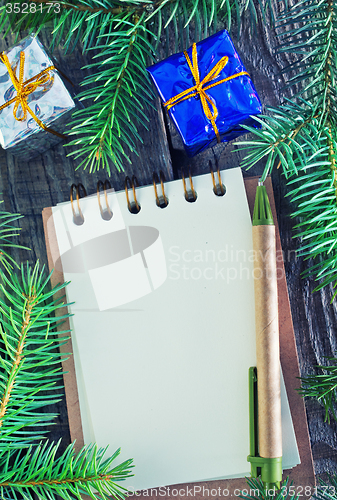 Image of notebook and christmas decoration