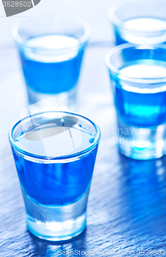 Image of blue alcoholic drink into small glasses