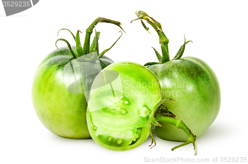 Image of Two whole and half green tomatoes