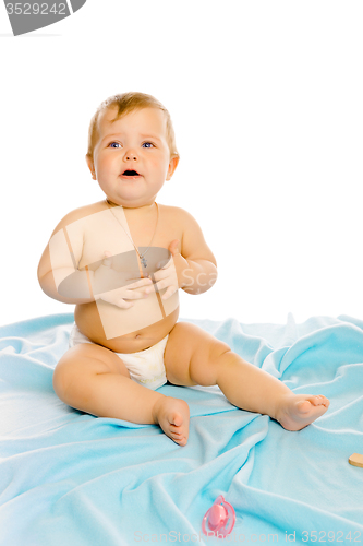 Image of upset baby in diapers. Studio