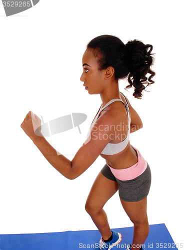 Image of Young african american woman running.