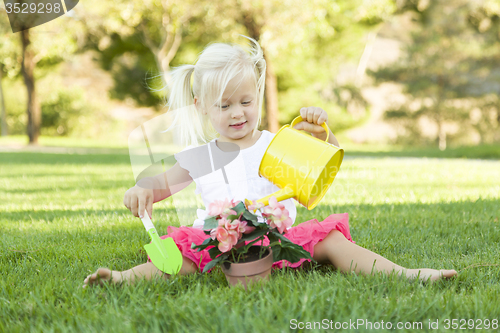 Image of Little Girl Playing Gardener with Her Tools and Flower Pot