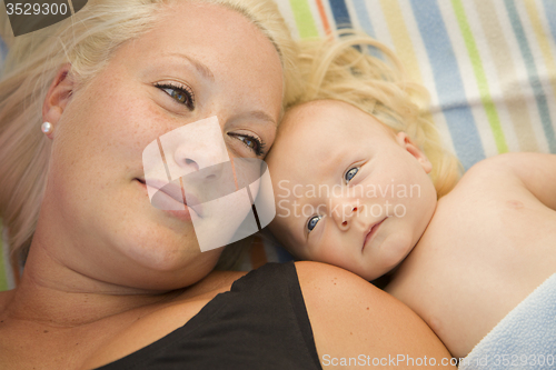 Image of Cute Baby Boy Laying Next to His Mommy on Blanket