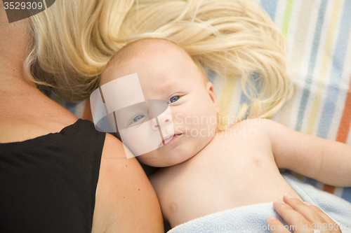 Image of Cute Baby Boy Laying Next to His Mommy on Blanket