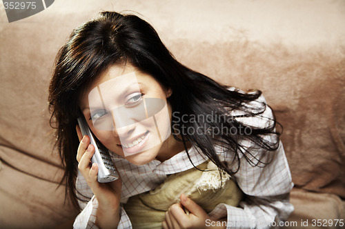 Image of young woman is speaking on cell phone