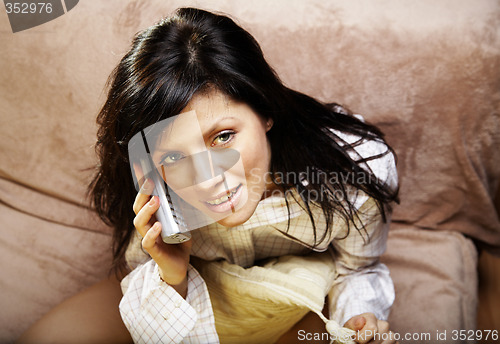 Image of young woman is speaking on cell phone