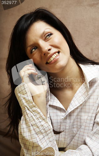 Image of young woman is speaking on cell phone