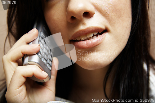 Image of young woman is speaking on cell phone
