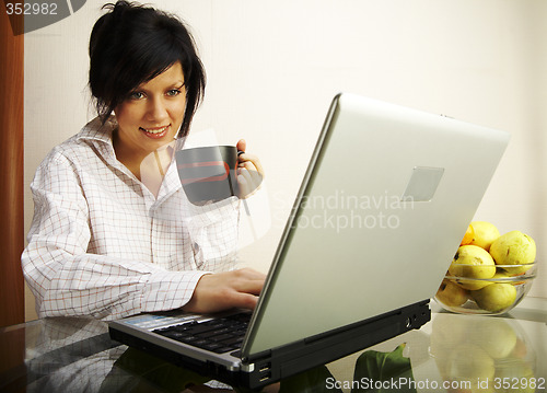 Image of beautiful caucasian woman with laptop