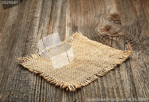 Image of burlap napkin on wooden table
