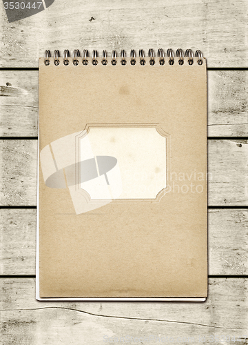 Image of Closed spiral Note book on a white wood table