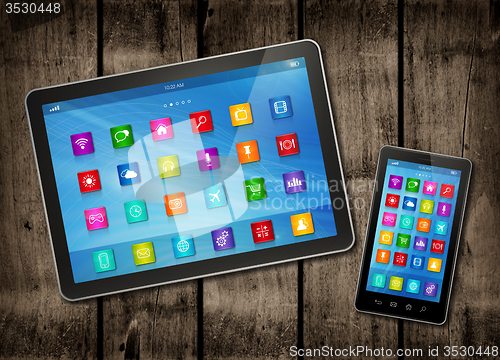 Image of Smartphone and digital tablet PC with desktop icons on a dark wo