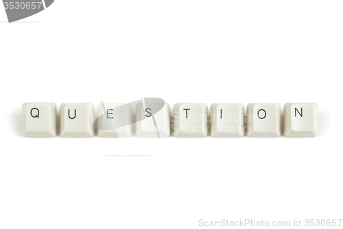 Image of questions from scattered keyboard keys on white