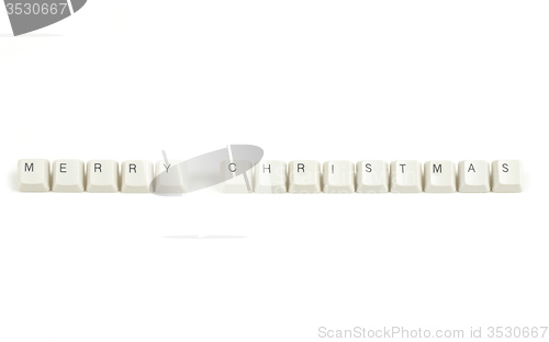 Image of merry christmas from scattered keyboard keys on white