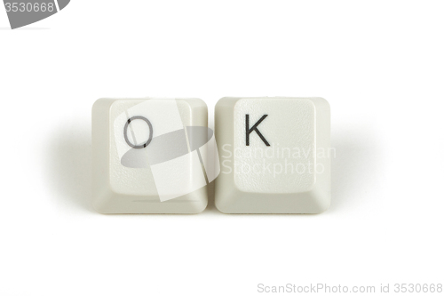 Image of ok from scattered keyboard keys on white