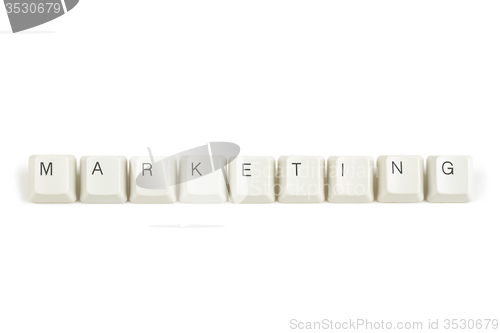 Image of marketing from scattered keyboard keys on white