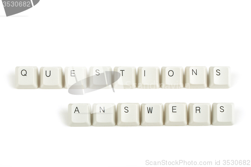 Image of questions answers from scattered keyboard keys on white