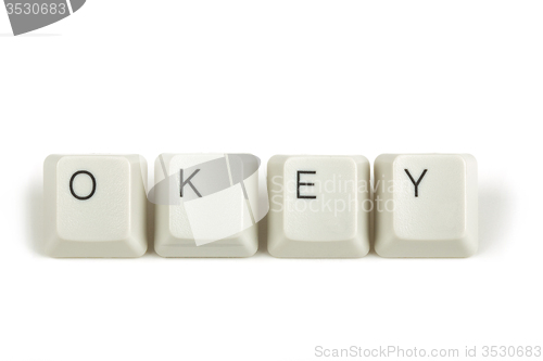 Image of okey from scattered keyboard keys on white