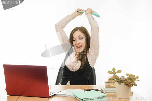 Image of The teacher has a book on a laptop