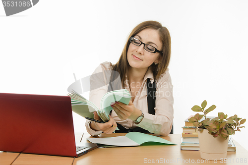 Image of The teacher is holding a notebook students