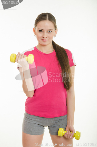 Image of Sportswoman doing exercises with dumbbells