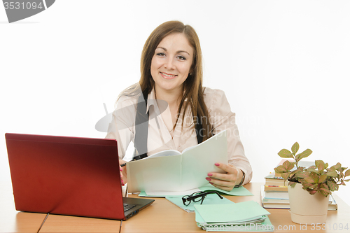 Image of Portrait of a smiling teacher at your desk