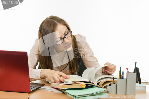 Image of Teacher reading something in a textbook