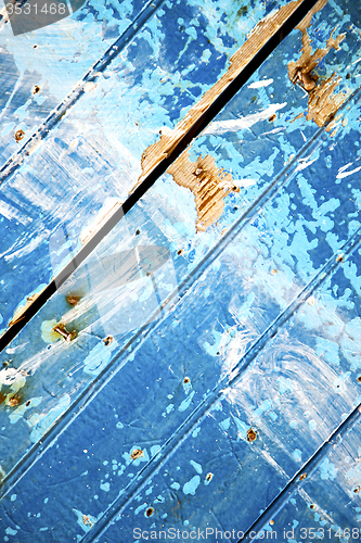 Image of nail stripped   in the blue wood door  rusty 