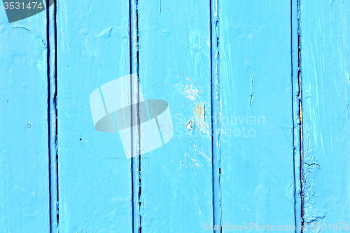 Image of stripped paint in   blue wood door  nail