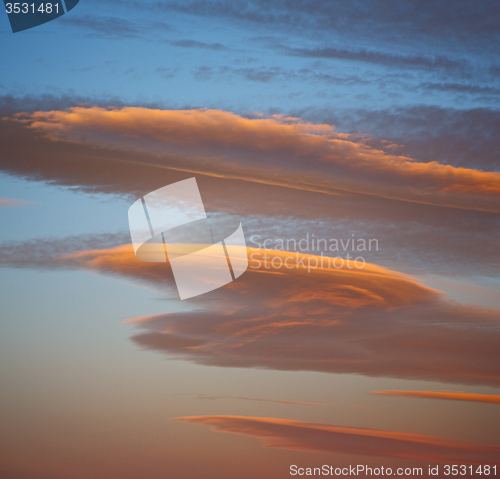 Image of sunrise in the colored sky white soft clouds and abstract backgr