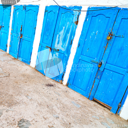 Image of in africa morocco  old harbor wood   door and the blue sky