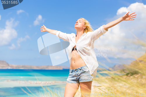 Image of Free Happy Woman Enjoying Sun on Vacations.