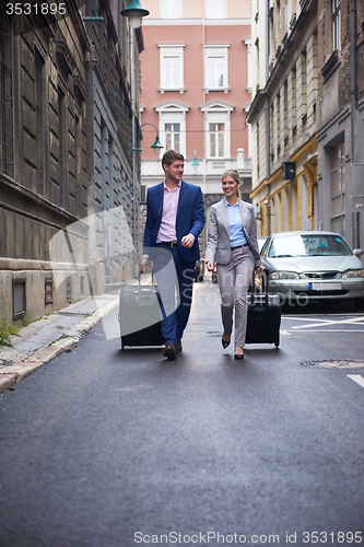 Image of business people couple entering  hotel