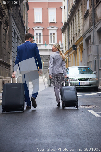 Image of business people couple entering  hotel