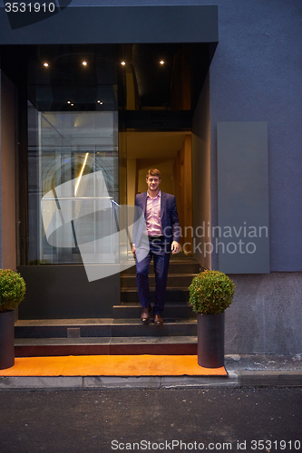 Image of business man entering  hotel