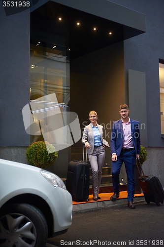 Image of business people couple entering  hotel