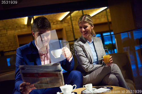 Image of business couple take drink after work